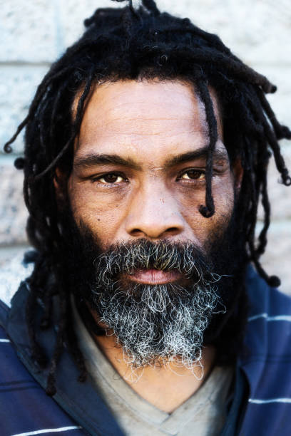 istock Man with dreadlocks looks intensely at the camera 959128304