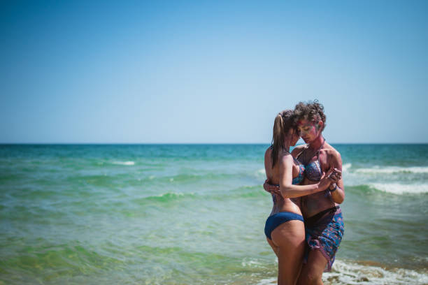istock Female friends dancing on the beach 959134040