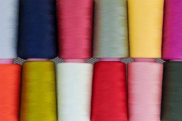 istock Sewing threads on spool in the white metal grid, close up. 959134420