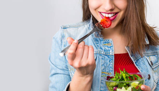 istock Woman eating healthy salad 959135620