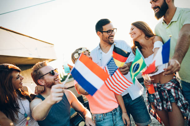 istock Group of people holding national flags 959140910