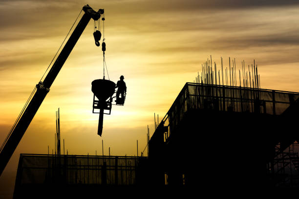 istock Silhouette crane construction building at sunset, Industrial construction 959141128