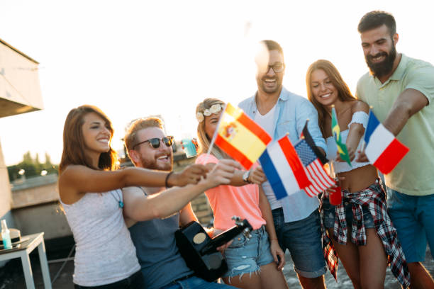 istock Group of people holding national flags 959141250
