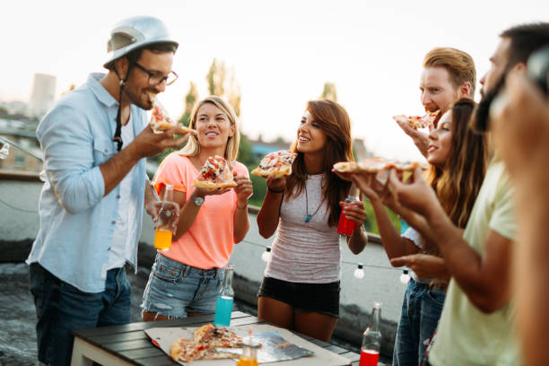 istock Group of happy friends having party on rooftop 959141486