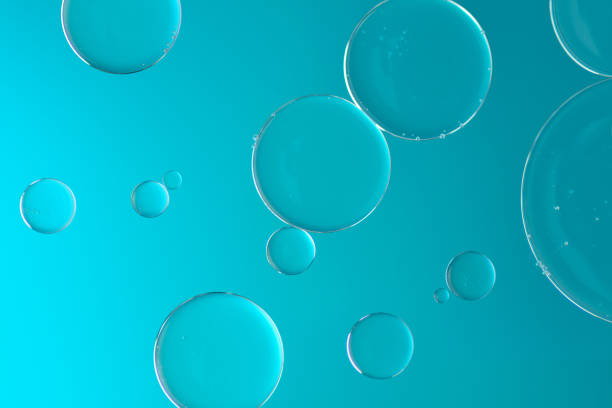 istock Water and oil on light blue background - Abstract macro 959141702
