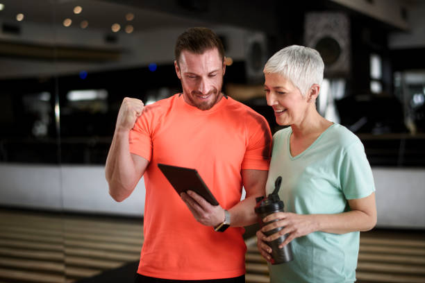 istock Active senior woman and fitness instructor 959141914