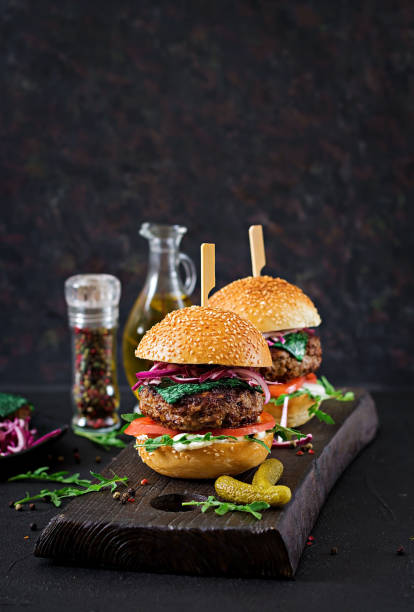 istock Big sandwich - hamburger burger with beef,  tomato, basil cheese and arugula. 959143092
