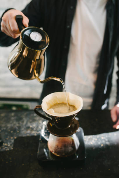 istock Bbarista pours hot water over grounded coffee 959146972