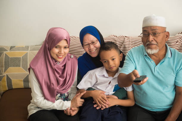 istock Modern multigenerational family realxing at home 959147570