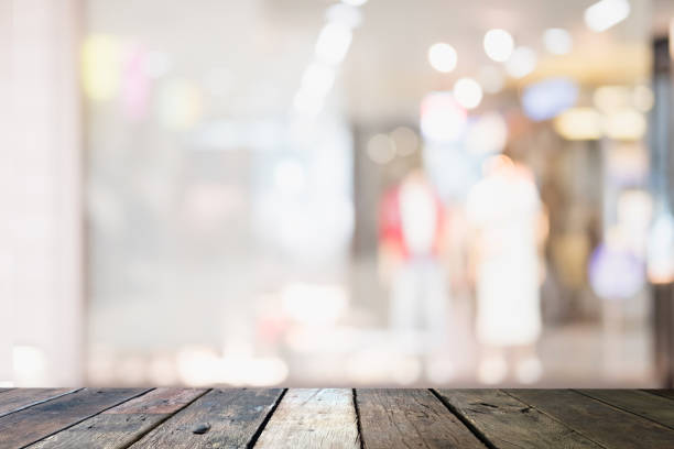 istock Wooden board empty table blurred background. Perspective brown wood table over blur in cloth shop background - can be used for display or montage your products. Mock up for display of product. 959147670