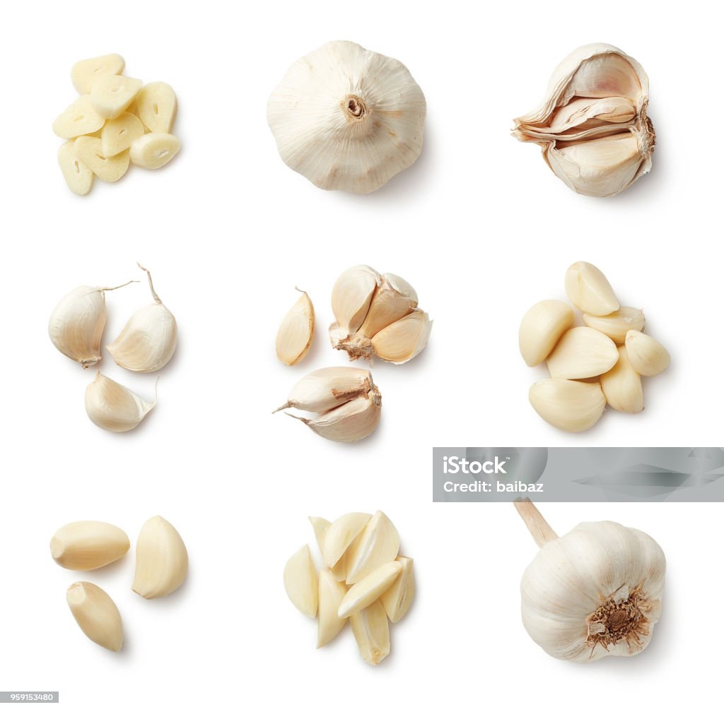 Set of fresh whole and sliced garlics Set of fresh whole and sliced garlics isolated on white background. Top view Garlic Stock Photo