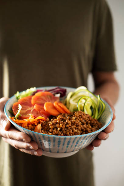 istock young man with a buddha bowl 959153726