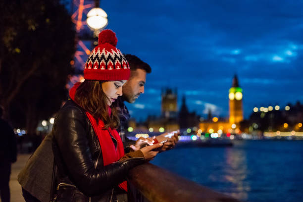 istock Woman using smart phone in the night in London 959156046