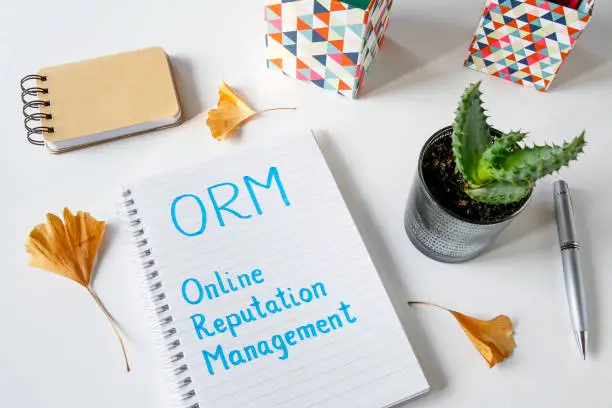 Photo of ORM Online Reputation Management written in notebook