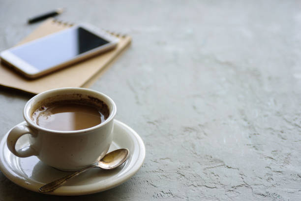 istock Cup of coffee on desk or workspace 959156430