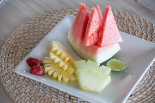 istock Tropical fruits assortment on a white plate. Fruit plate for breakfast pn plate 959156712