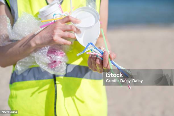 Close Up Of Person Collecting Plastic Waste From Polluted Beach Stock Photo - Download Image Now