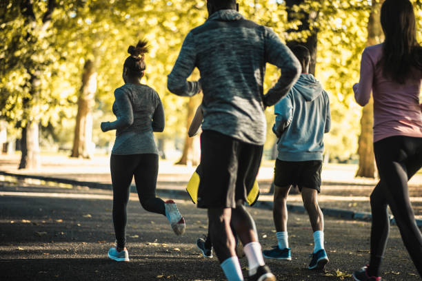 istock Friends running together in the park 959161658