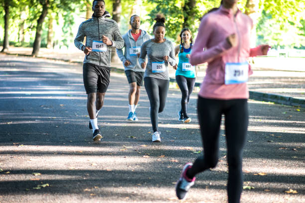 istock Group of friends running track in a park 959161670