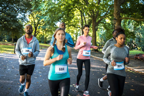 istock Group of friends running track in a park 959161676