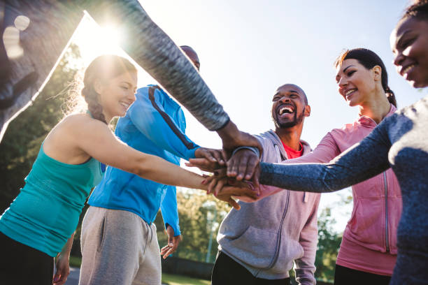 istock Group of friends holding hands in a huddle 959161732