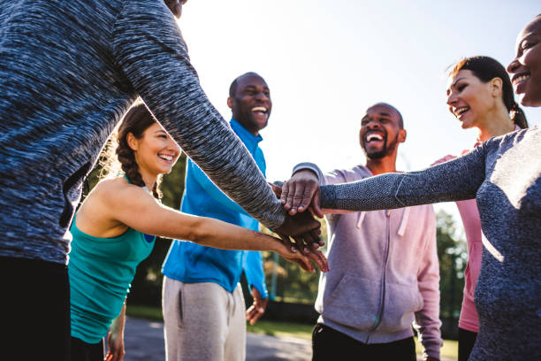 istock Friends holding hands in a huddle 959161734