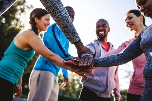 istock Friends holding hands in a huddle 959161736
