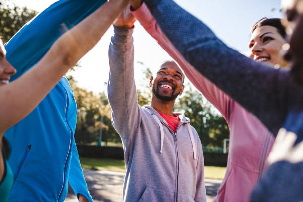 istock Group of friends holding hands in a huddle 959161738