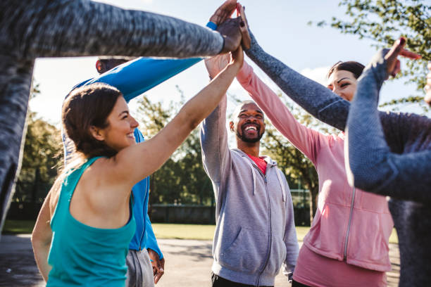istock Group of friends holding hands in a huddle 959161740