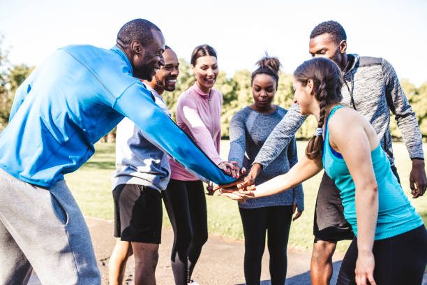 istock Friends holding hands in a huddle 959161754