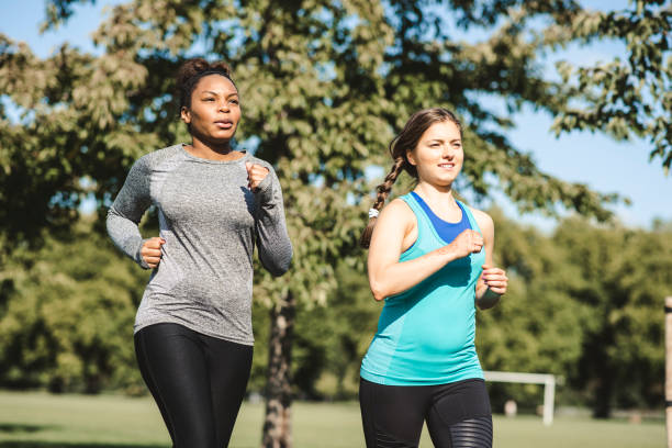 istock Friends running together in the park 959161808