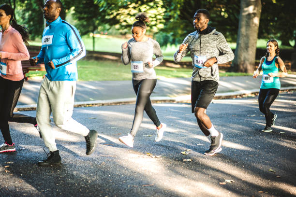 istock Group of people running track together in a park 959161812