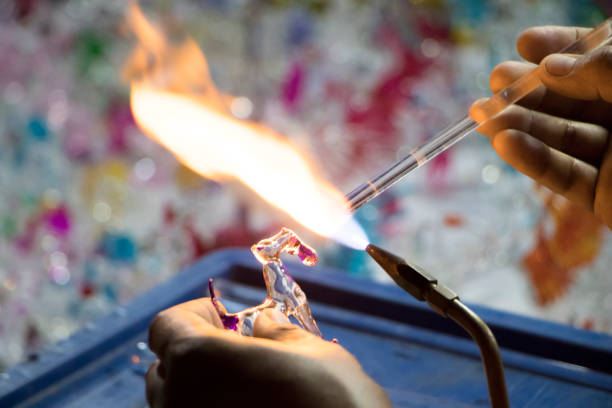 Handicraft from glass blowing.Worker use high temperature to melting glass and forms it shape to various shape craft product.
