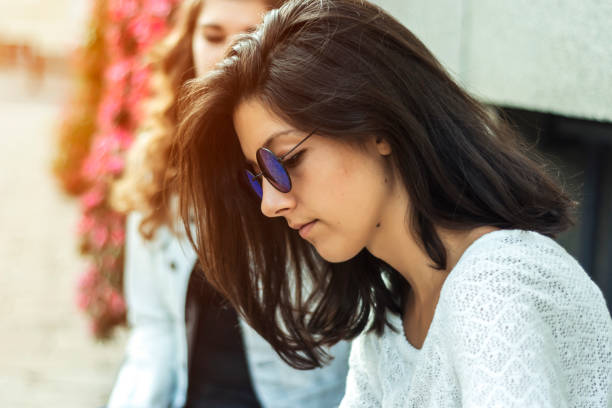 istock Sad woman sitting on a bench 959166952