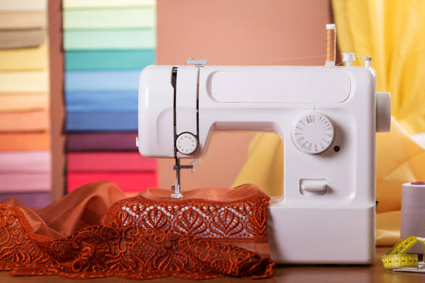 istock Household sewing electric machine in operation, behind fabric samples 959170596