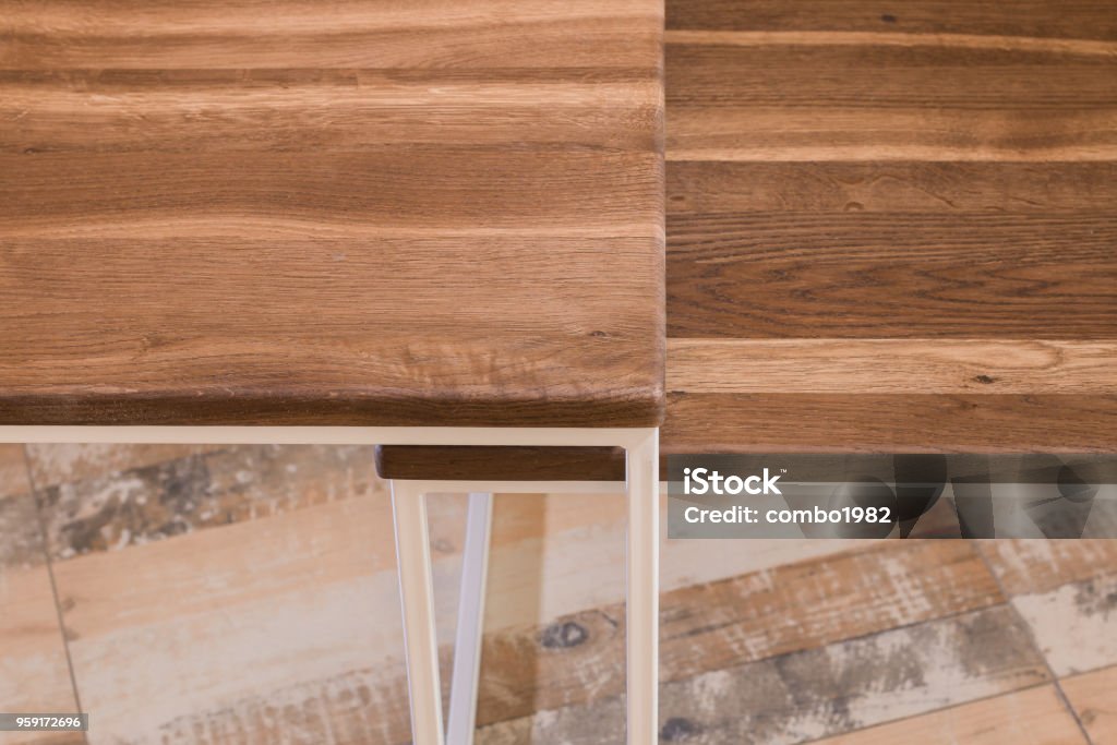 Bedside wooden table in loft style in a room of wood Bedside wooden table in loft style in a room of wood. Art Stock Photo