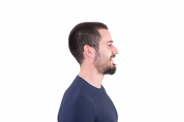 istock Profile view of young man looking away with content smile on a white background 959173740