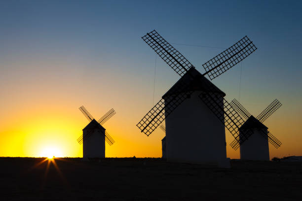 istock Silhouettes of traditional windmills at Campo de Criptana site, Spain 959175840
