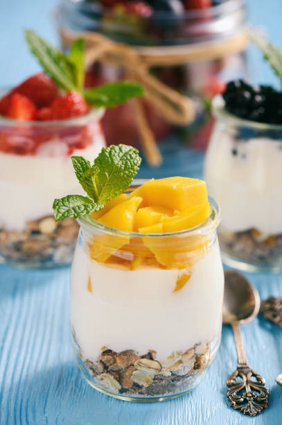 istock Natural yogurt with muesli, mango and berries. 959175880