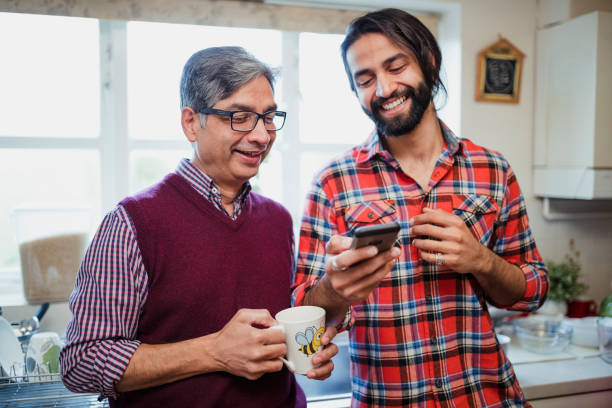 istock Man and Father Looking at Smartphone Together 959176190