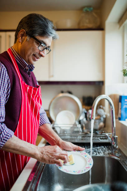 istock Mature man Washing Dishes at Home 959176686