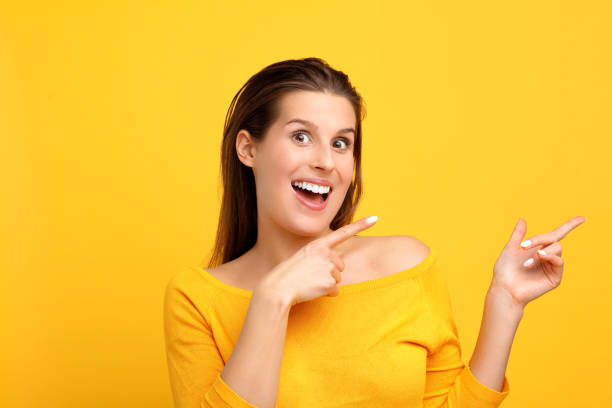 istock Woman against yellow wall background 959180880
