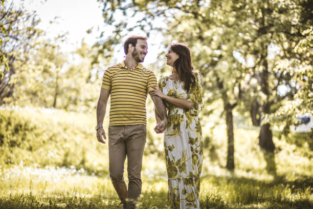 istock Walking trough nature. Heterosexual couple. 959181074