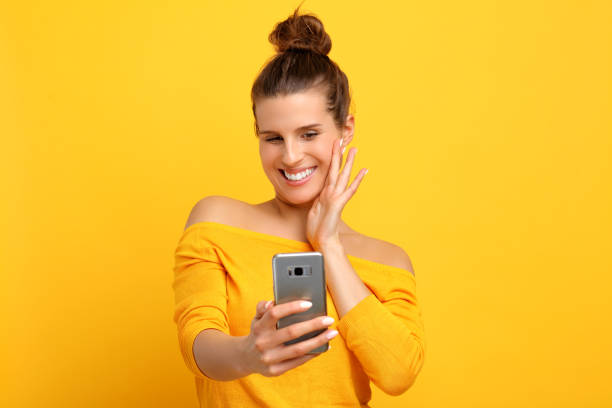 istock Woman against yellow wall background 959181786