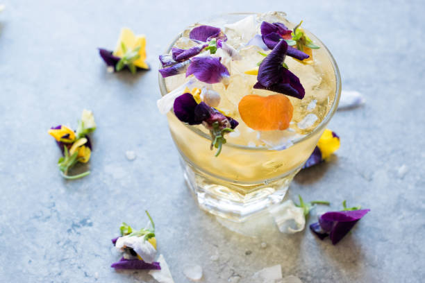 Herbal Iced Tea Cocktail with Edible Flowers and Crushed Ice.
