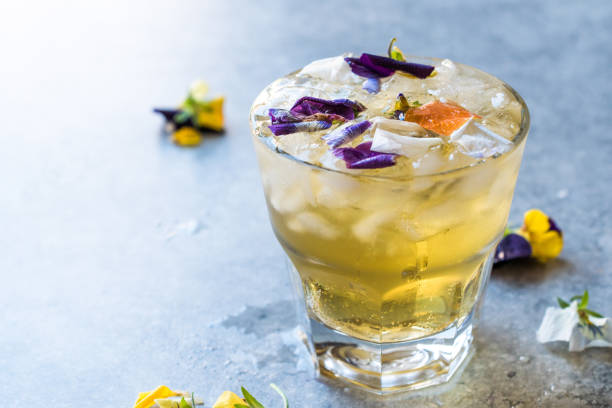 istock Herbal Iced Tea Cocktail with Edible Flowers and Crushed Ice. 959184776