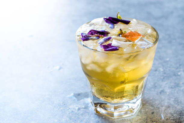 istock Herbal Iced Tea Cocktail with Edible Flowers and Crushed Ice. 959184934