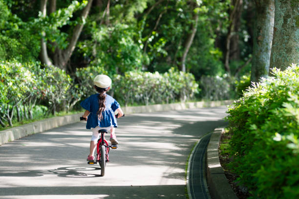 istock Girl playing on a bicycle 959186462