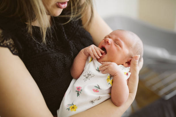 istock Young mother holding baby in her arms 959190476
