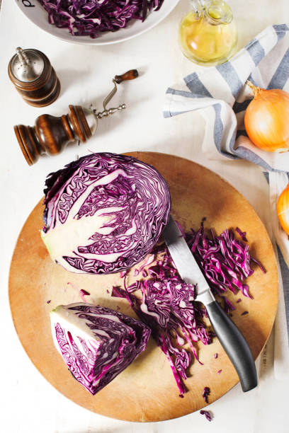 istock Shredded red cabbage on wooden cutting board. 959193214